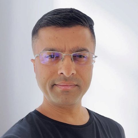 Punit, head and shoulders, wearing glasses and a dark top